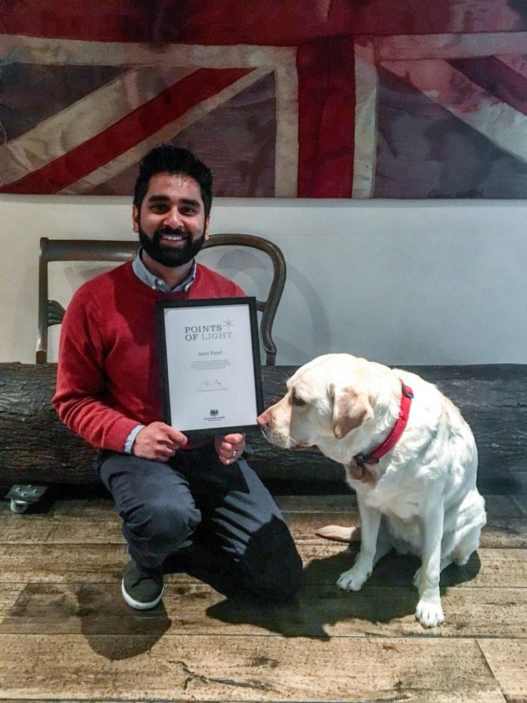 Dr Amit Patel with Guide Dog Kika and his award