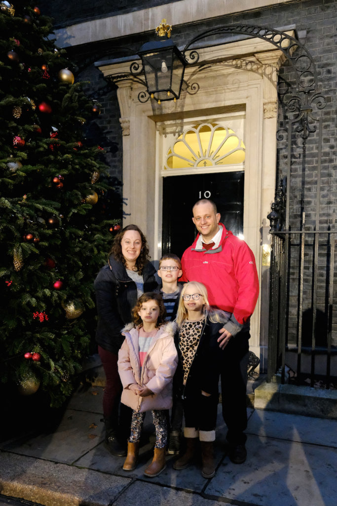 Point of Light Maisie Sly with her family outside Downing Street for the Christmas lights switch on