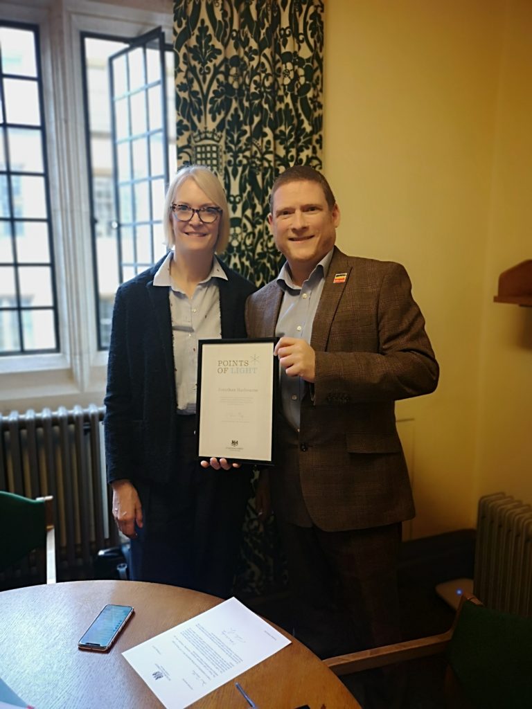 Margot James MP presenting Jonathan with his Points of Light award