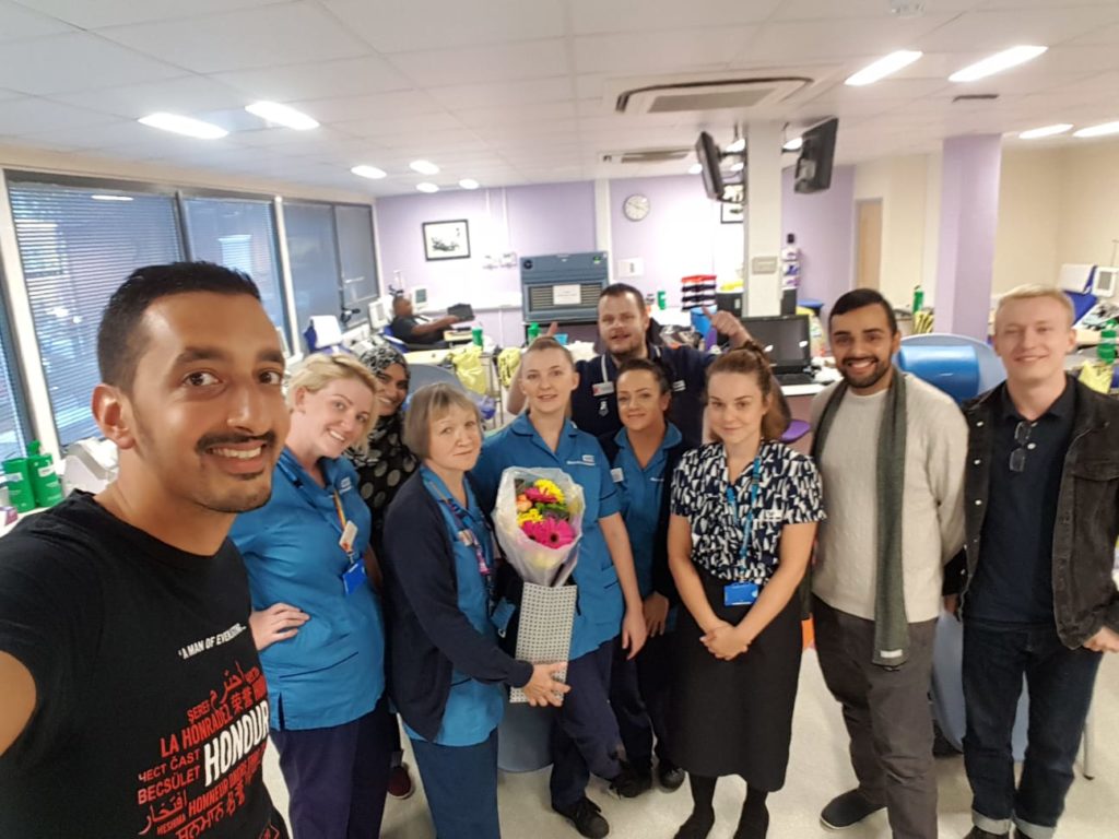 Mustafa with volunteers and NHS staff