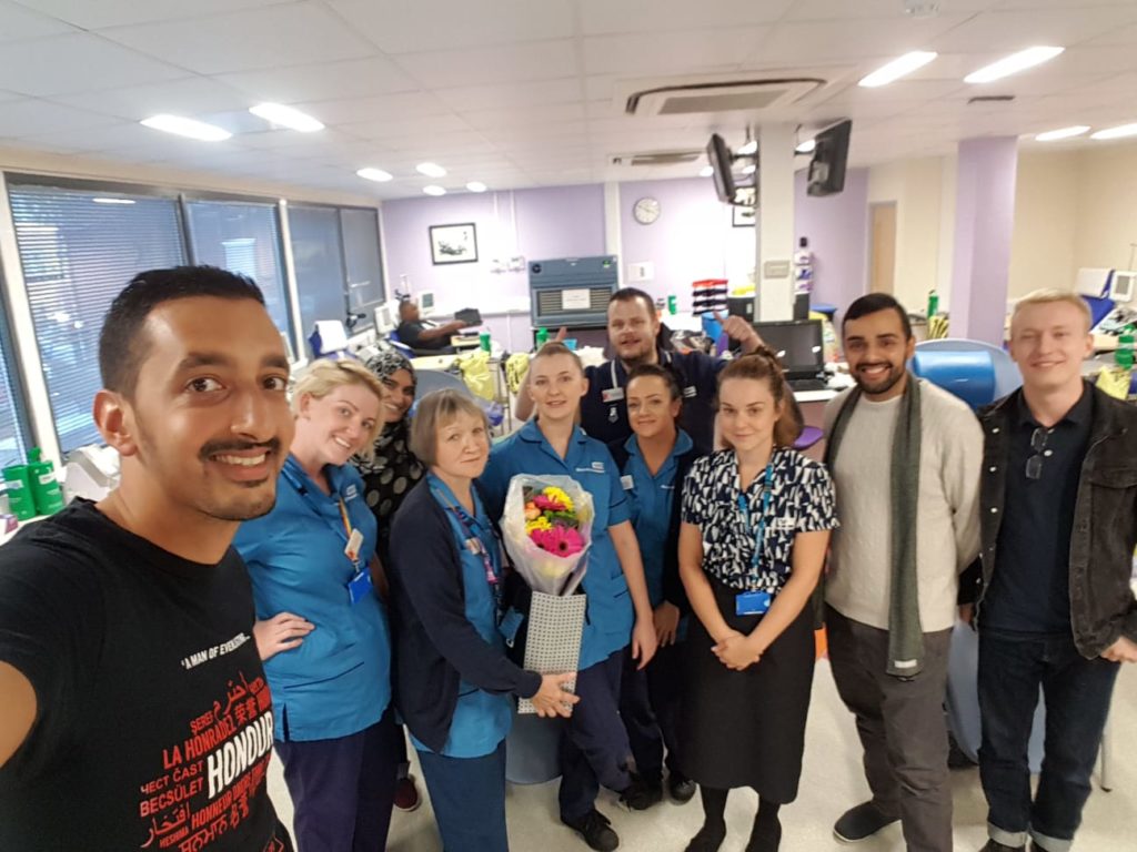 Mustafa with volunteers and NHS staff