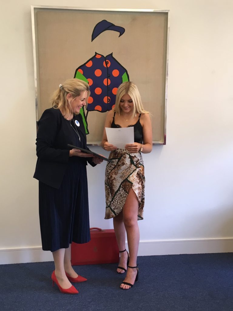Jess Ridge receiving her award from Mims Davies MP