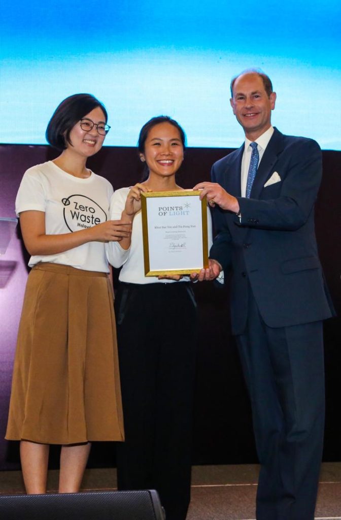 Prince Edward presents with the Commonwealth Points of Light award to Khor Sue Yee and Aurora Tin