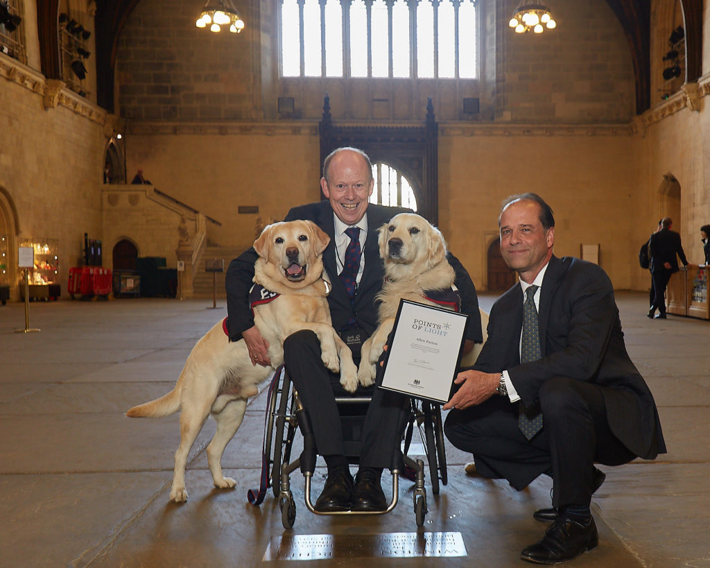 Allen receiving his Points of Light award from Sir George Hollingbery MP