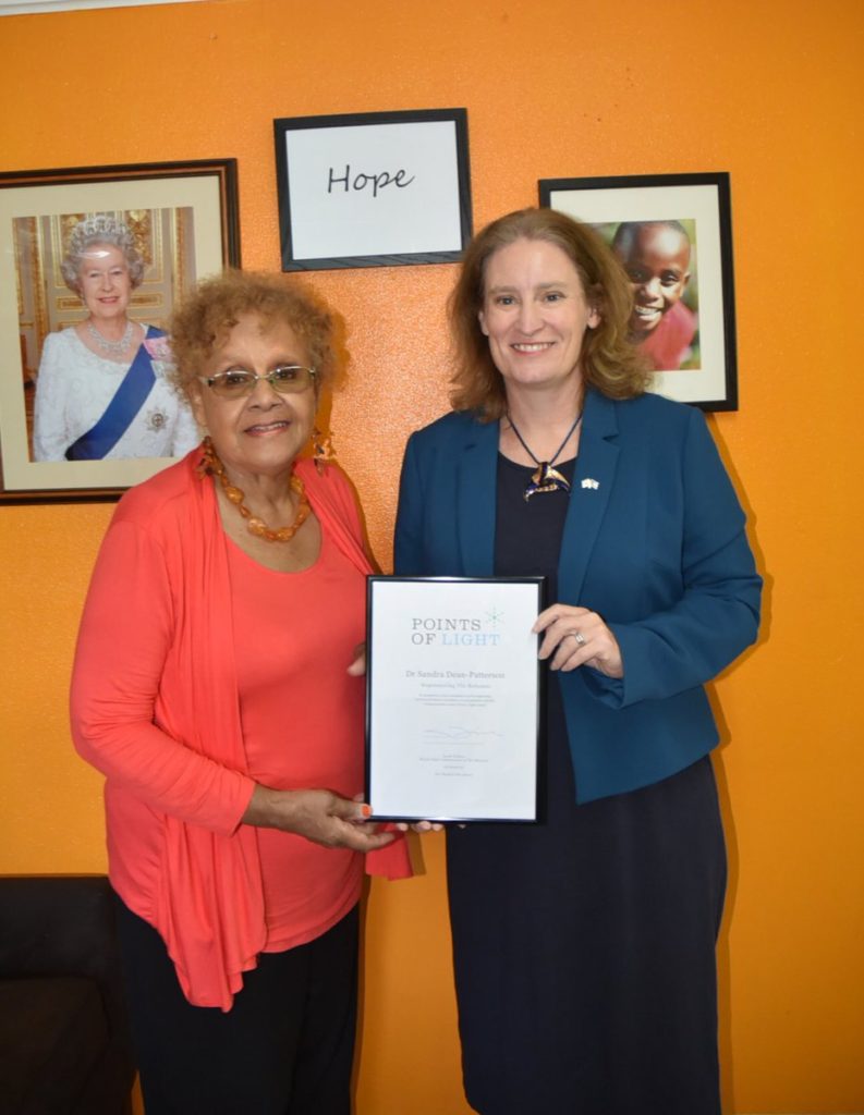 Dr Sandra Dean-Patterson receiving her award from UK High Commissioner in the Bahamas Sarah Dickson