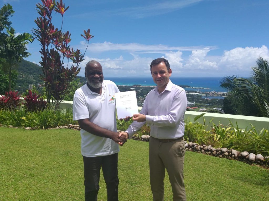Victorin receives his Commonwealth Points of Light award from Patrick Lynch, UK High Commissioner in the Seychelles