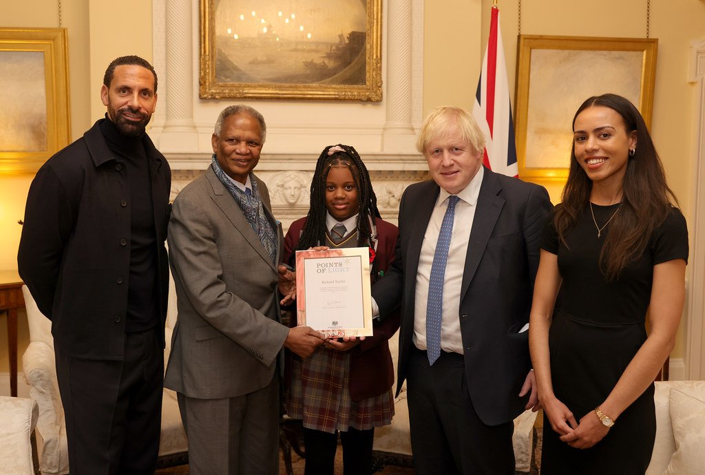 Richard Taylor presented with his Points of Light award by PM Boris Johnson, and joined by Rio Ferdinand