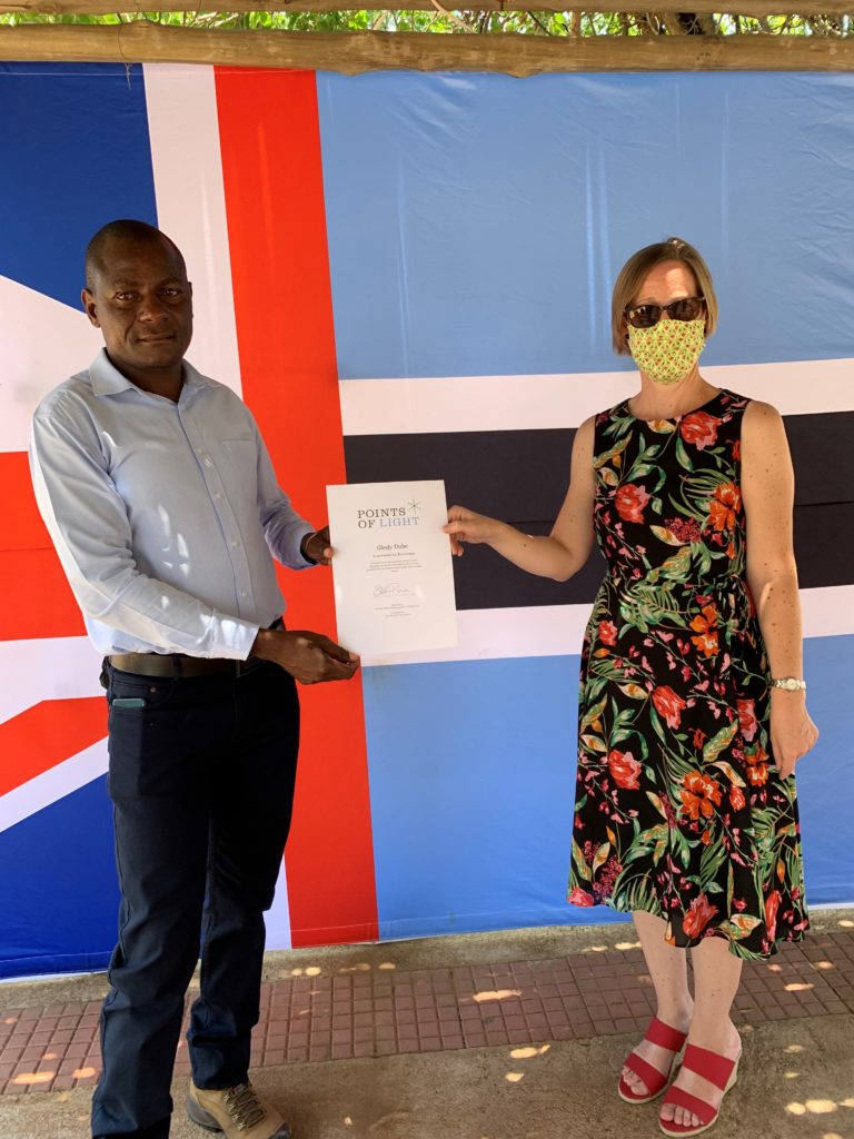 Glody Dube receiving his award from British High Commissioner to Botswana Sian Price