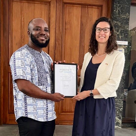 Eric receiving his award from Harriet Thompson, British High Commissioner to Ghana