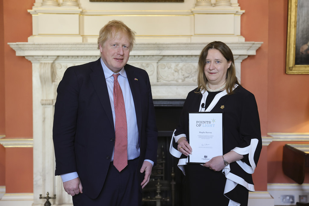 Magda Harvey receiving her Points of Light award from Prime Minister Boris Johnson