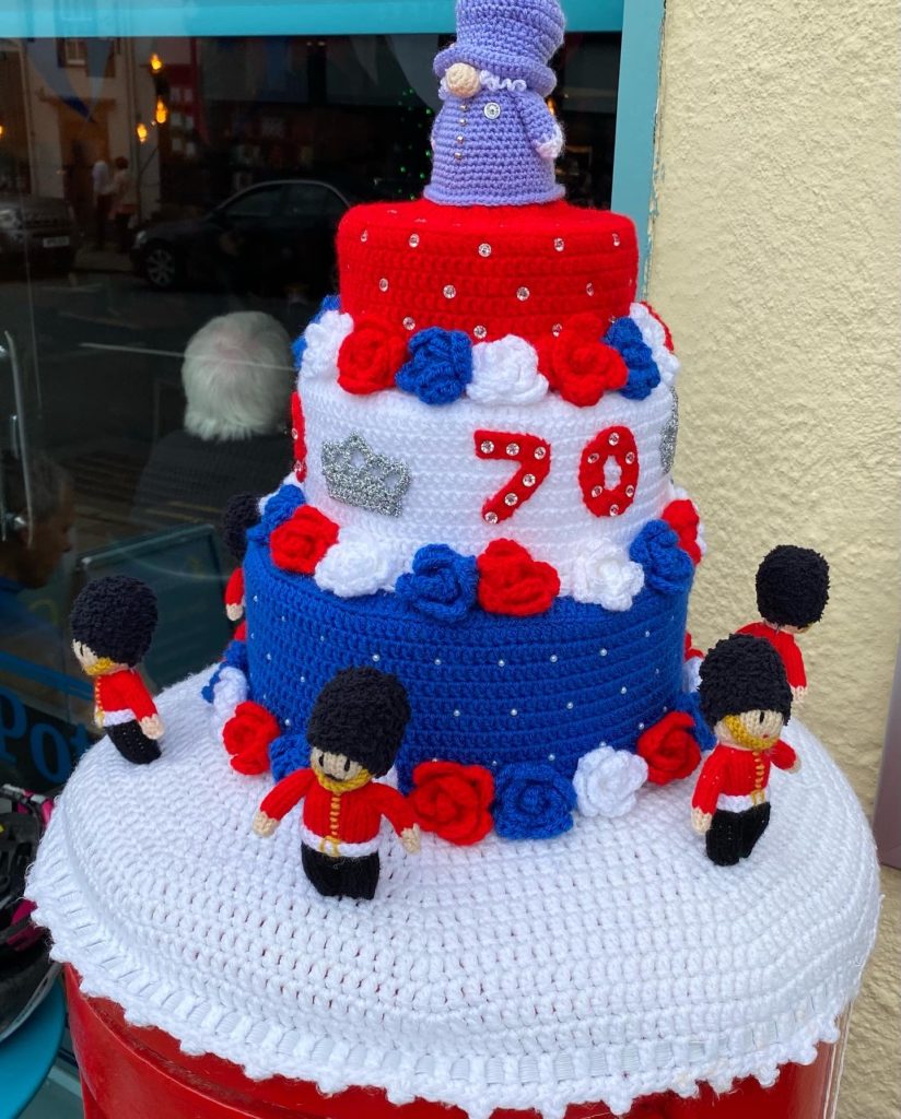 Knitted topper of a Platinum Jubilee 70 years cake with Royal Guardsman