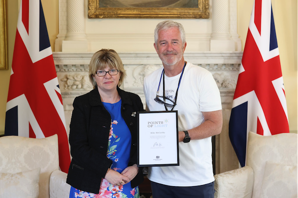 Mike McCarthy presented with his Points of Light award by Health Minister Maria Caulfield MP at No10 Downing Street at an event marking the end of the Baton of Hope relay tour